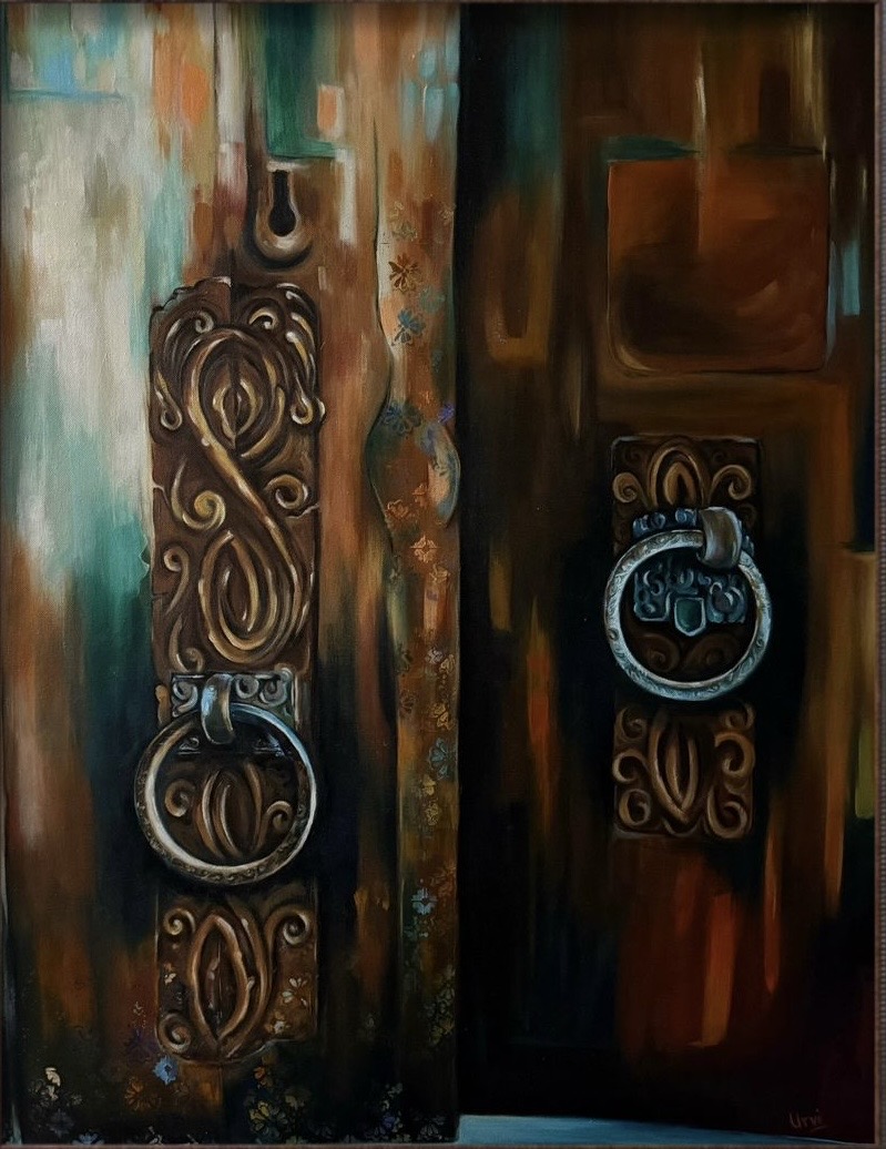 Ornate metal knockers on a wooden double door.
